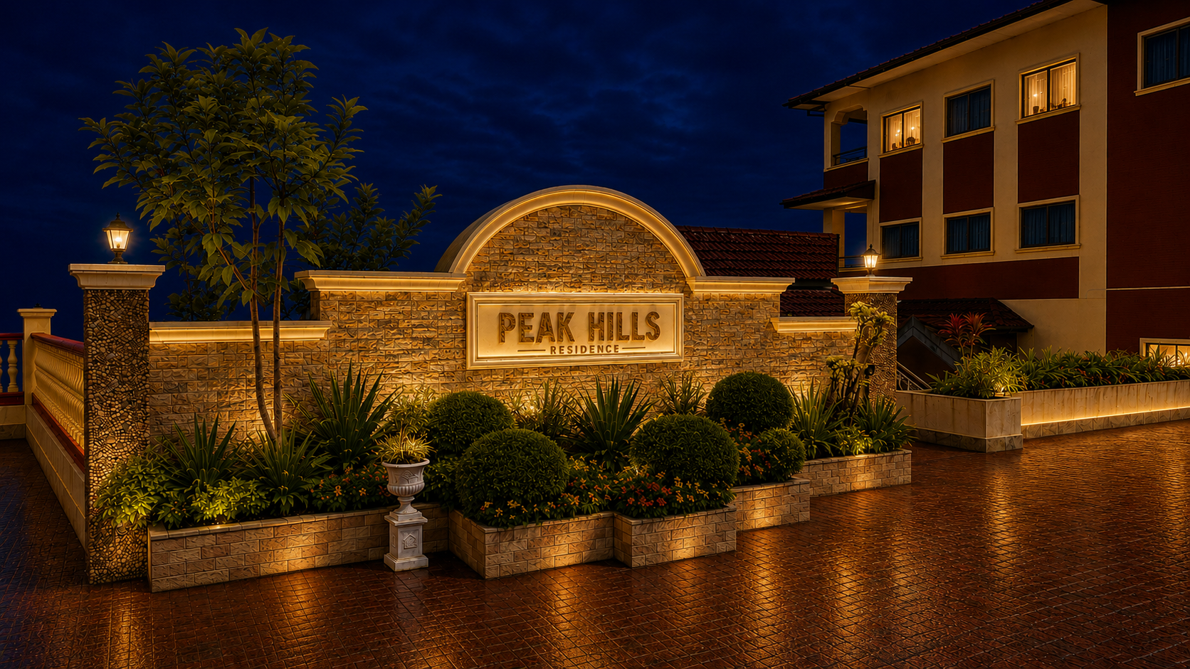 The stone entrance sign of Peak Hills Residence at night, lit from below